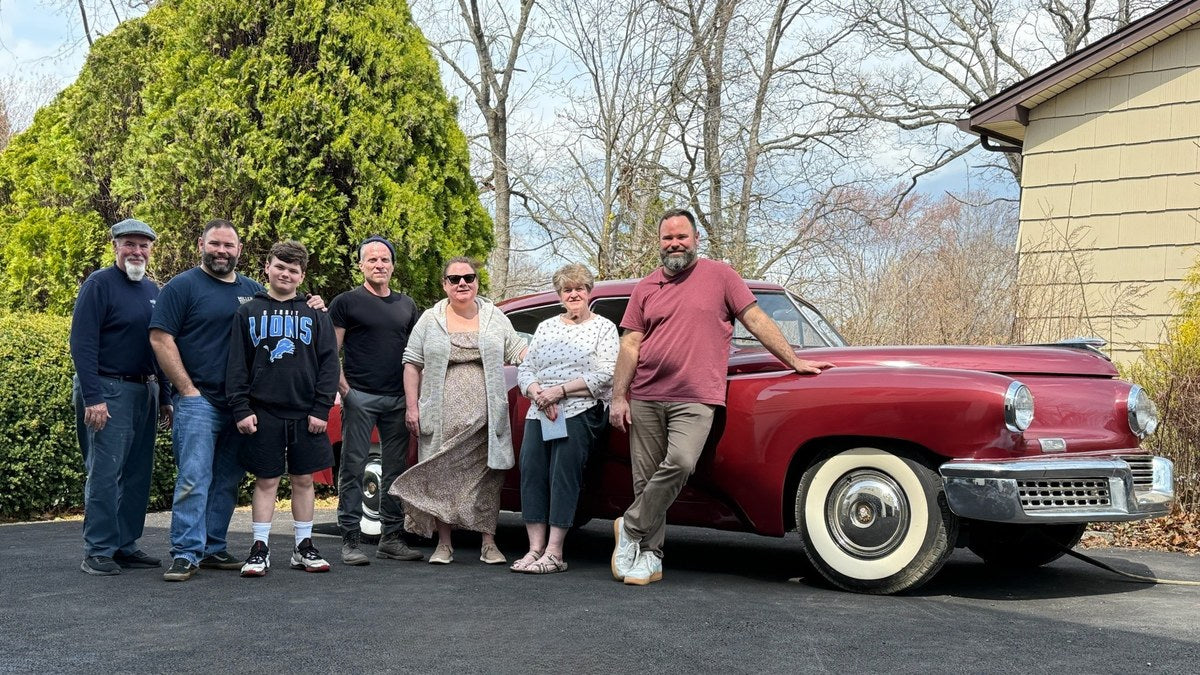 Family and friends gathered beside Tucker #1051 in a New Jersey driveway