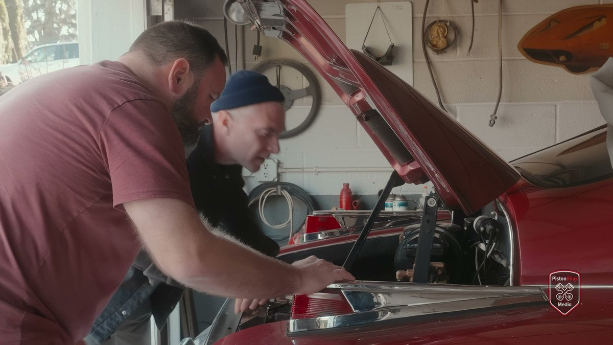 Sean Tucker and Rob Ida look over the engine of Tucker #1051
